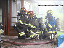 Fireman preparing to make entry to a structure fire.